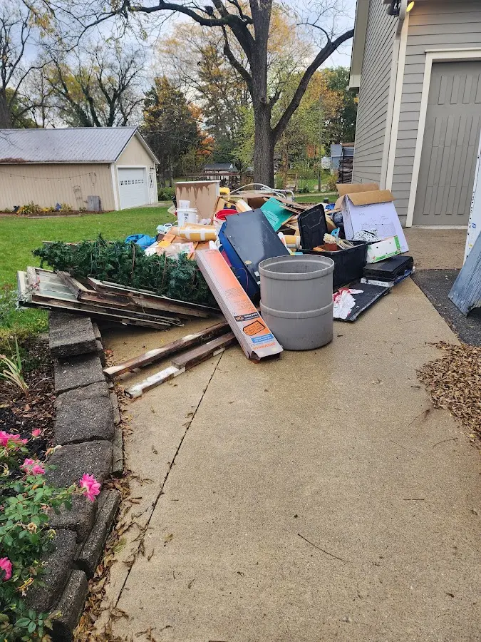 Dumpster being loaded with debris for Estate Cleanout Dumpster Rental in Harwinton
